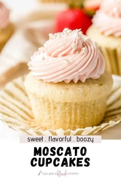 a close up of a cupcake on a plate with strawberries in the background