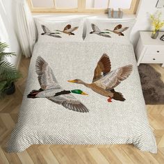 two ducks flying in the air on a bed