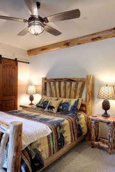 a bedroom with a bed, nightstands and ceiling fan