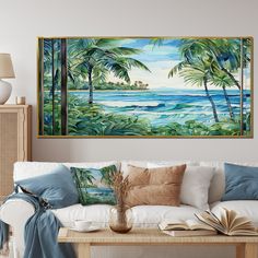 a painting hanging on the wall above a couch with pillows and other items in front of it