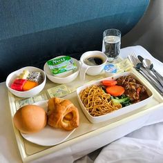 an airplane tray with food and drinks on it