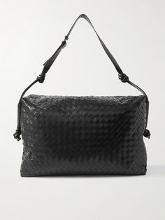 Bottega Veneta's holdall is a smart choice for weekend breaks or short-haul trips. It's been crafted from strips of leather, woven using the house's signature intrecciato technique, and has a spacious, canvas-lined interior that'll hold a change of clothes, laptop and grooming essentials. An internal snap-fastening pocket is ideal for securing smaller items, like your chargers. Designer Travel Shoulder Bag With Interwoven Design, Designer Travel Bags With Interwoven Design, Luxury Shoulder Bag With Interwoven Design For Travel, Leather Holdall, Tom Ford Bag, Bottega Veneta Intrecciato, Weekend Breaks, Luxury Sneakers, Driving Shoes