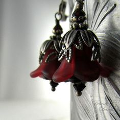 "Deep, burgundy wine colored blossoms are capped in leafy layers of antique silver and accented with garnet swarovski crystals. **Note...the sun is shining thru these, they are actually a deep wine color with out the sun. These lovely vintage style, romantic earrings are a perfect gift for that special someone with a January birthday. Total length from top of earwire: 1.5\"(40mm) Flower itself is only about 1/2\"( 12mm) Prefer a different style of earwire? French earwires, kidney wires, non-pier Elegant Red Handmade Flower Earrings, Elegant Handmade Red Flower Earrings, Red Flower Earrings For Formal Occasions, Formal Red Flower Earrings For Pierced Ears, Elegant Red Flower Earrings For Anniversary, Unique Red Wedding Earrings, Vintage Red Flower Earrings For Gift, Red Flower-shaped Earrings For Anniversary, Red Flower Earrings For Anniversary