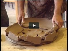 a person is making clay on a table