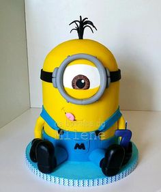 a cake that looks like a minion sitting on top of a white countertop