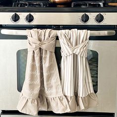 two towels hanging on the front of an oven