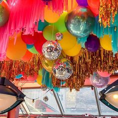 colorful balloons and streamers hang from the ceiling