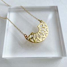 "Powell Gold Plated Pendant on gold Plated Chain. Approx. pendant measurements: 3/4\"L x 1.5\"W. Necklace length: 17.5\"L plus 2\" extender ." Gold Crescent Brass Jewelry, Nickel-free Gold Crescent Jewelry, Adjustable Gold Necklace With Flower Pendant, Gold Brass Necklace With Moon Charm, Brass Moon Charm Necklace For Gift, Adjustable Crescent Brass Necklace, Gold-plated Crescent Charm Necklaces, Gold-plated Crescent Charm Necklace, Gold Metal Moon Charm Necklace