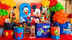 a mickey mouse party with balloons and decorations