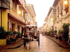 a horse drawn carriage on a cobblestone street in an old european town at dusk