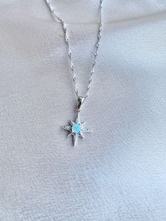 "925 Sterling Silver Opal North Star necklaces. high-quality, and very precious. The North Star, formally known as \"Polaris,\" has served as a beacon of inspiration and hope for many. Pendant size is 1.5 x 1.5 cm. Also available in Rose Gold over Sterling Silver and 18k Gold over Sterling Silver. Stone: Genuine Ethiopian Opal dimeter 4 mm. Sterling Silver 925 chains length can be adjusted from 18\" to 20\". Opal is known for its unique display of flashing rainbow colors known as play-of-color. Celestial Star Of David Necklace With Star Charm, Celestial Starburst Necklace With Star Charm, Celestial Style Star Charm Pendant Necklace, Celestial Star-shaped Sterling Silver Jewelry, Sterling Silver Star-shaped Clavicle Chain, Celestial Star-shaped Silver Jewelry, Sterling Silver Star Clavicle Chain, Silver Star-shaped Celestial Charm Necklaces, Silver Celestial Necklace With Star Charm