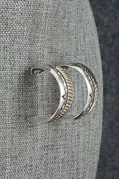 This pair of sterling silver and gold fill hoop earrings were made by Navajo silversmith Bruce Morgan. The backs are signed B Morgan and stamped 14k and Sterling.Length: 7/8"Width: 1/2"Free shipping on all orders! We ship with USPS and always include tracking. All orders ship within a day of payment.Returns are accepted up to 30 days after you receive your order. Just send us a message. Our shop offers cash back or store credit. The item must be returned in new condition. Silver Southwestern Hoop Earrings As Gift, Silver Southwestern Hoop Earrings For Gift, Southwestern Silver Round Hoop Earrings, Gold Filled Hoops, Silver And Gold, Gold Filled, Silver Gold, Hoop Earrings, Sterling Silver