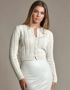 a woman wearing a white skirt and sweater