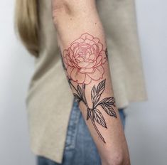 a woman with a rose tattoo on her arm