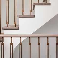 an image of a stair case with wood handrails and metal bars on it