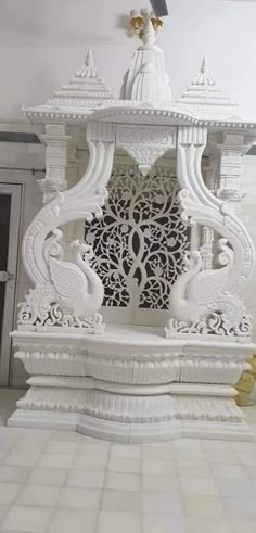 an intricately designed white shrine with gold accents