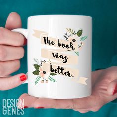 a woman holding a white coffee mug with the words, book was better on it