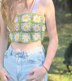 a woman with her hands on her hips wearing shorts and a cropped tank top