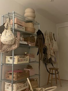 a room with several shelves and baskets on the floor