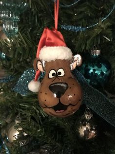 a christmas ornament hanging on a tree with ornaments in the shape of a dog's head