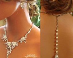 the back of a woman's neck wearing a necklace with pearls and flowers on it