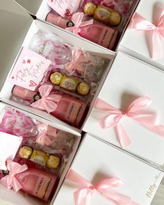 three boxes with pink and gold wrapped wine bottles in them, one is for someone's birthday