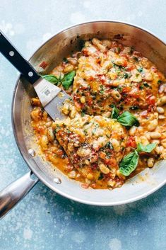 a pan filled with some food and a spatula on top of the skillet