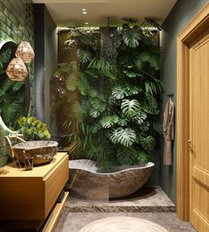 a bath room with a large tub and a plant covered wall behind the shower stall