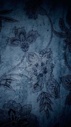 an old wallpaper with flowers and leaves on the blue background is seen in this image