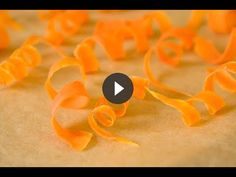 an image of orange pasta spirals on a sheet of paper with the video title