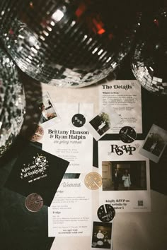 an assortment of brochures and other items on a table with disco balls in the background