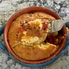 a close up of a bowl of food with a spoon in it