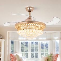 a living room filled with lots of furniture and a chandelier above the couch