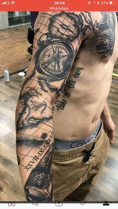 a man's arm with a compass and map tattoo on the left side of his arm