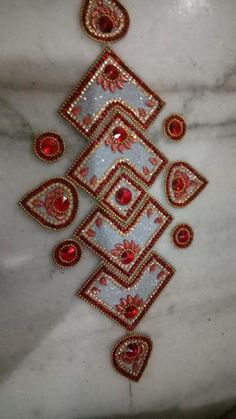 red and white beaded necklace on a marble surface with an intricate design in the center