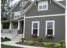 a gray house with white trim and windows