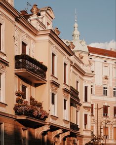 an old building with balconies and flower boxes