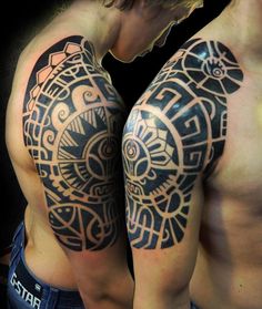 two men with tattoos on their arms