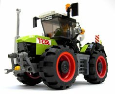 a toy tractor with red wheels on a white background