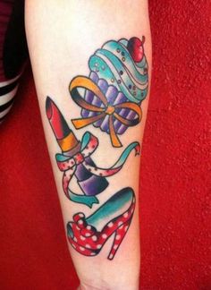 a person with a tattoo on their arm that has an image of two clowns