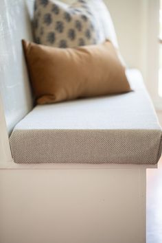 a white couch with pillows on top of it