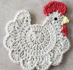 a crocheted chicken ornament is shown on the ground