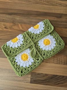 a crocheted dishcloth with yellow and white flowers