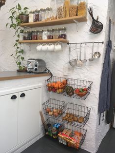 a kitchen with shelves filled with food and cooking utensils