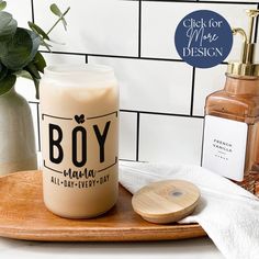 a bottle of body lotion sitting on top of a wooden tray next to a soap dispenser