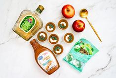 the ingredients to make apple cider donuts laid out on a marble surface