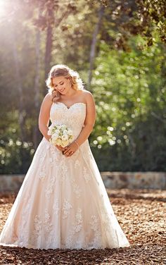 a woman in a wedding dress is posing for the camera with her hand on her face