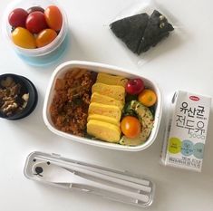 there are many different types of food in the bowl on the table, including tofu and vegetables