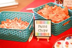 the table is set up with different types of chips and cupcakes on it