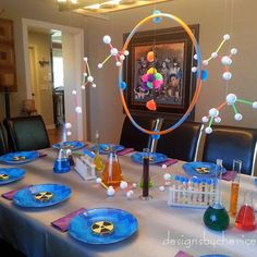 the table is set with blue plates and glasses for an outer space themed birthday party